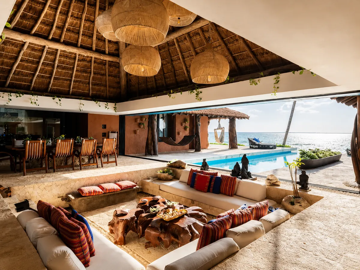 Casa Corazon's palapa living room opening to the pool and the Caribbean