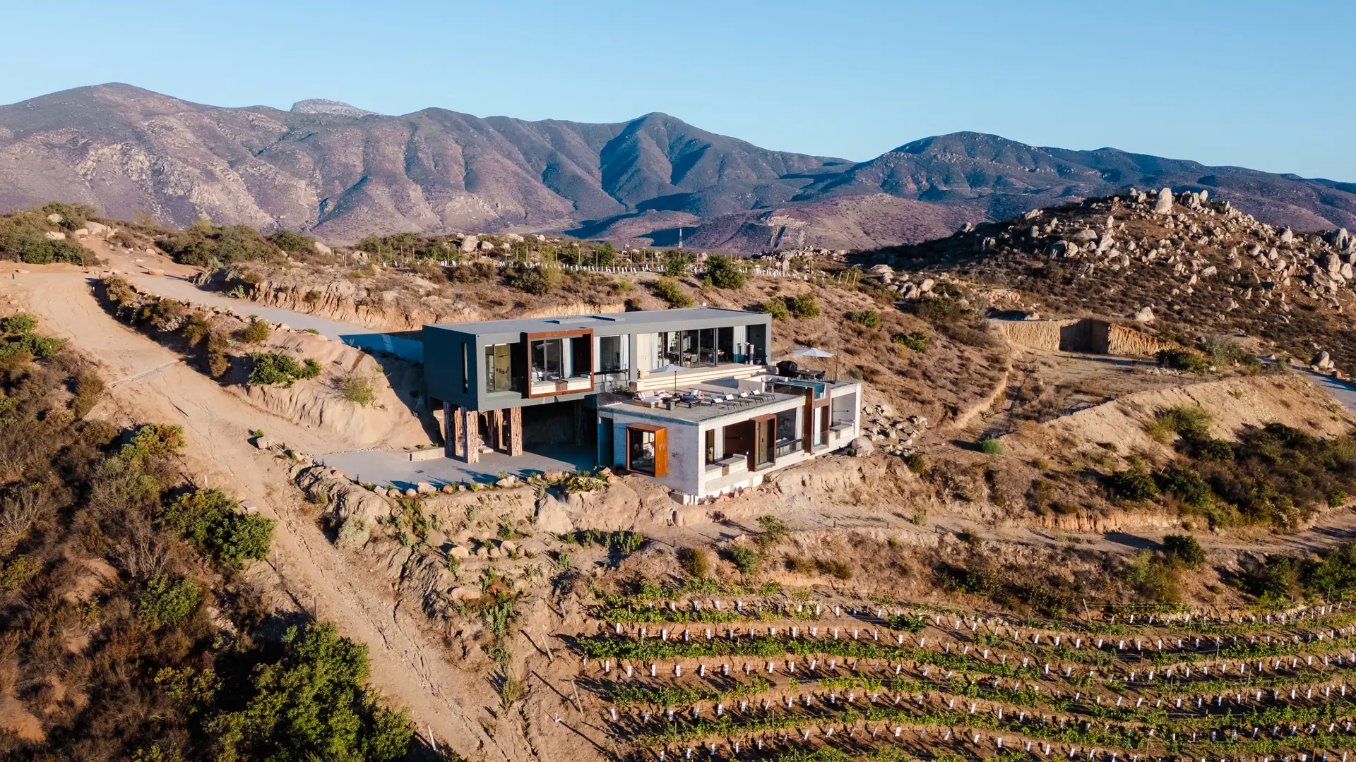 Aerial view of Kasa Kefi, a modern concrete villa above the vineyards of Valle de Guadalupe