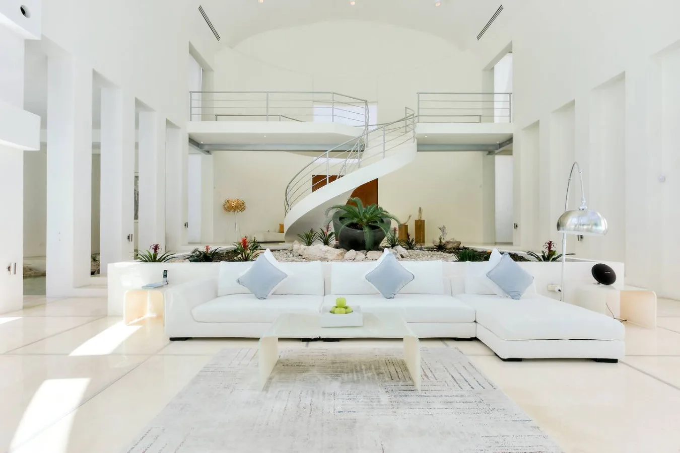 The double-height living room beneath Villa Aqua's spiral staircase